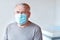 Elderly man in a medical office getting ready for vaccination. Portrait of senior man wearing medical mask for Covid -19