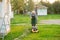 Elderly man mowing lawn.