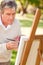 Elderly man painting