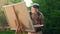 Elderly man painting on a canvas