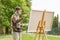 Elderly man painting on a canvas