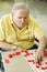 Elderly man playing bingo.