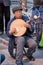 Elderly man playing traditional Chinese instrument in a park in Beijing, China