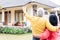 Elderly man pointing to his wife a comfortable residential house