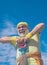 Elderly man practicing sports on blue sky background. Grandfather pensioner. Sporting. Senior sportsman in sport center