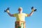 Elderly man practicing sports on blue sky background. Senior man lifting weights. Health for aged pensioner. Senior