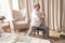 Elderly man practicing yoga asana warrior using chair