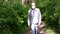 An elderly man in a protective mask walks in the Park, a walk in the fresh air after quarantine, a precautionary measure