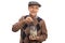 Elderly man putting a coin into a jar with money