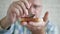 Elderly Man Putting Sweet and Flavored Fruit Jam on a Slice of Bread for Breakfast in the Morning.