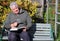 Elderly man reading with magnifying glass.