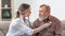Elderly man at regular medical checking with therapist worried chronic aged disease health problem