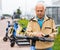 Elderly man rents an electric scooter using mobile phone