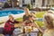 Elderly man serving food on a tray while having lunch with friends in the backyard