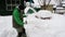 Elderly man shoveling snow in yard