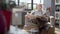 Elderly man sits in a chair and reading a newspaper in a modern apartment