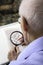 Elderly man sitting doing crosswords hobby