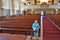 Elderly man sitting in an empty church