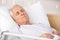 Elderly man sleeping in hospital bed