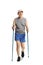 Elderly man in sportswear walking with trekking poles