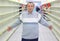 Elderly man stands between empty shelves in shop