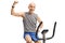 Elderly man on a stationary bike flexing his biceps
