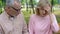 Elderly man supporting wife suffering headache, migraine symptom, health problem