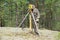 An elderly man is a surveyor at work in the overgrown taiga. Determination of coordinates