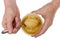 Elderly man takes golden summer honey  with a spoon from a plastic  bowl isolated