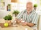 Elderly man taking pill at home