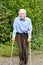 Elderly man using forearm crutches to walk