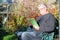 Elderly man wearing eyeglasses and reading a book