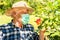 Elderly man wearing a protective mask in the domestic quarantine period in the garden.