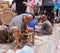 Elderly man weaves chair at the fair