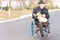 Elderly man in a wheelchair doing grocery shopping