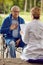 Elderly man in wheelchair who don`t feel good with nurse