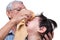 Elderly Man Wiping Tears from Child\'s Face, Senior man gently wipes away tears from young Asian child\'s face.