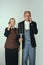 Elderly man and woman in art performance, replica of painting american gothic. Retro style, comparison of eras and