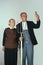 Elderly man and woman in art performance, replica of painting american gothic. Retro style, comparison of eras and