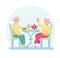 Elderly man and woman drink tea while sitting at the table