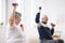 Elderly man and woman exercising with dumbbells during physiotherapy session at hospital