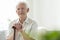 Elderly man with wooden walking stick in the nursing house