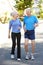 Elderly man and younger woman jogging