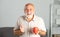 Elderly managing director with cup of tea. Mature caucasian man at home. Portrait of happy smiling senior businessman in