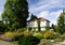 Elderly mansion with beautiful garden against a blue sky 3