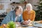 Elderly married couple making calculations together and looking involved