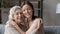 Elderly mother grown daughter hug with closed eyes touch heads