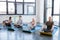 Elderly multiethnic people practicing yoga in