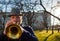 An elderly musician plays in the street on a trumpet