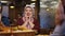 Elderly Muslim Woman in Hijab Praying at the Restaurant Before a Meal in Ramadan